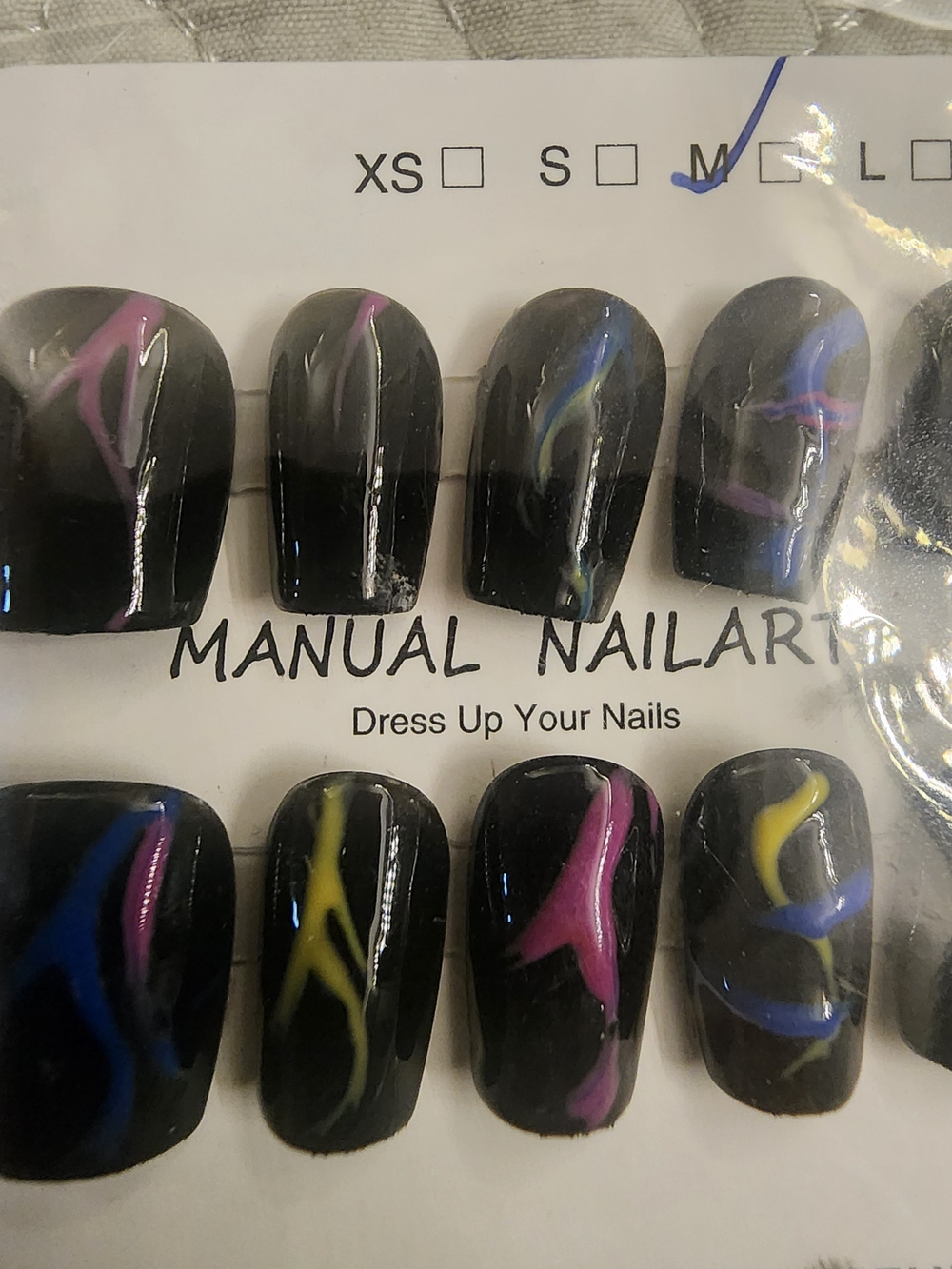 Molo Black Press-On Nails with Pink Blue and Yellow Swirl Accent